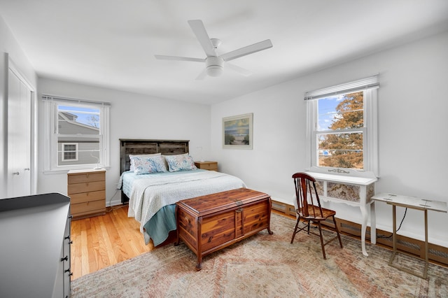 bedroom featuring multiple windows, ceiling fan, and light hardwood / wood-style floors