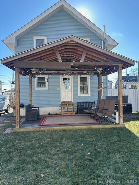 rear view of property with a yard