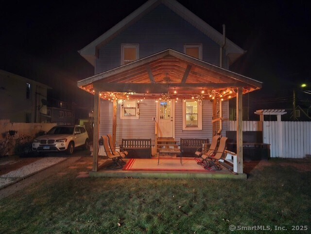 view of front of house featuring a patio and a lawn