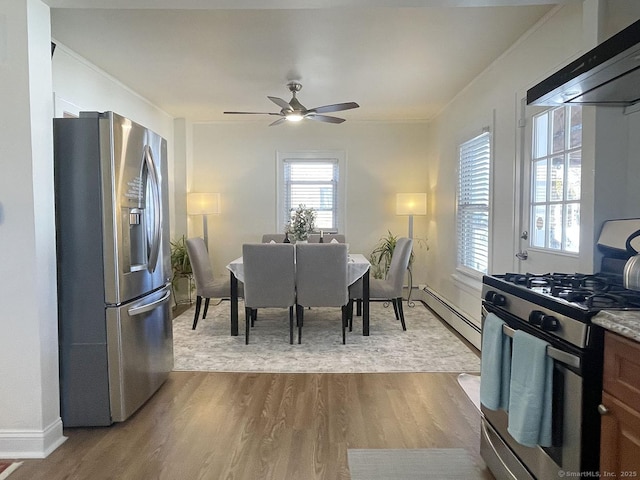 dining area featuring crown molding, light hardwood / wood-style flooring, ceiling fan, and baseboard heating