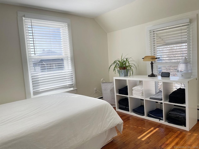 bedroom with lofted ceiling and hardwood / wood-style flooring