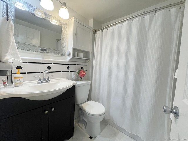 bathroom featuring tile walls, backsplash, vanity, walk in shower, and toilet