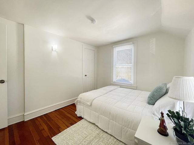 bedroom featuring hardwood / wood-style flooring and lofted ceiling