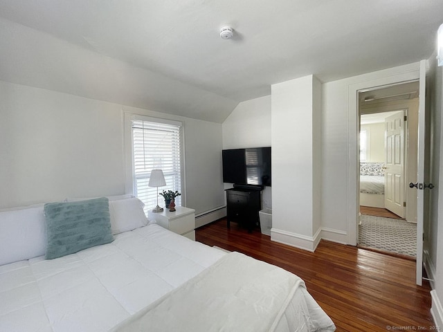 bedroom with wood-type flooring, vaulted ceiling, and a baseboard heating unit