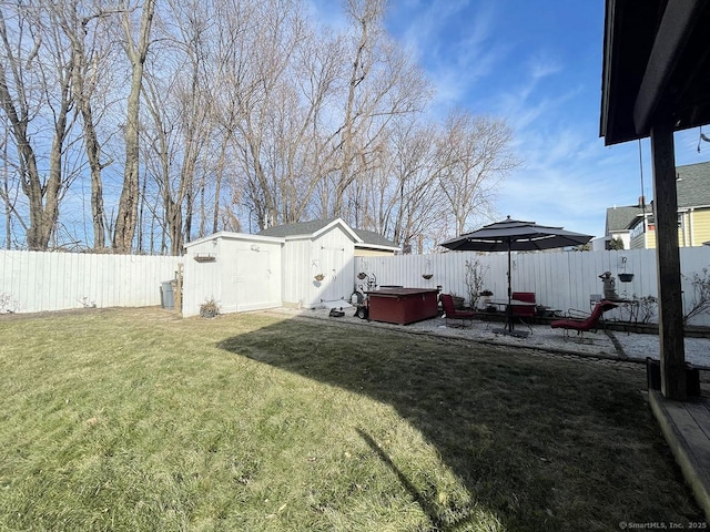 view of yard featuring a storage shed, a hot tub, and a patio