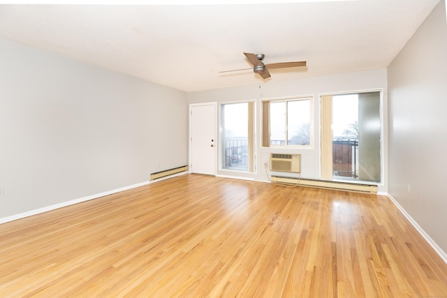 unfurnished living room with baseboard heating, light hardwood / wood-style floors, and an AC wall unit