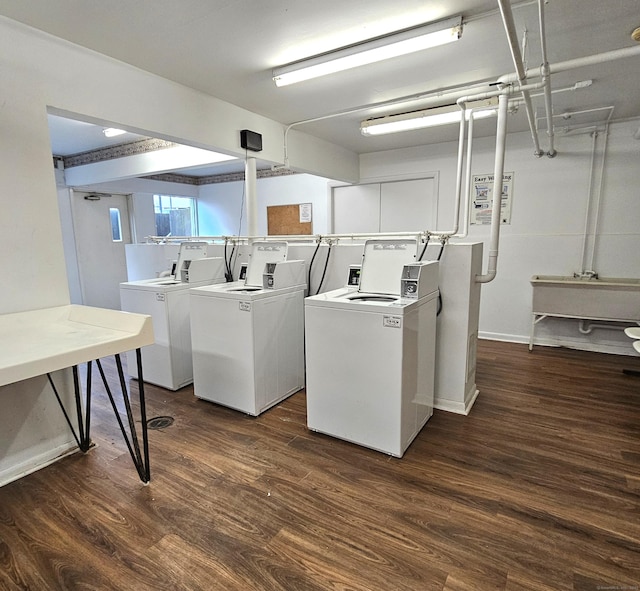 laundry area with dark hardwood / wood-style flooring and washer and dryer