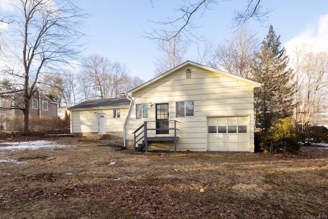 back of property with a garage