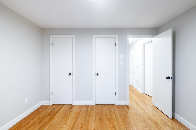 unfurnished bedroom featuring light wood-type flooring