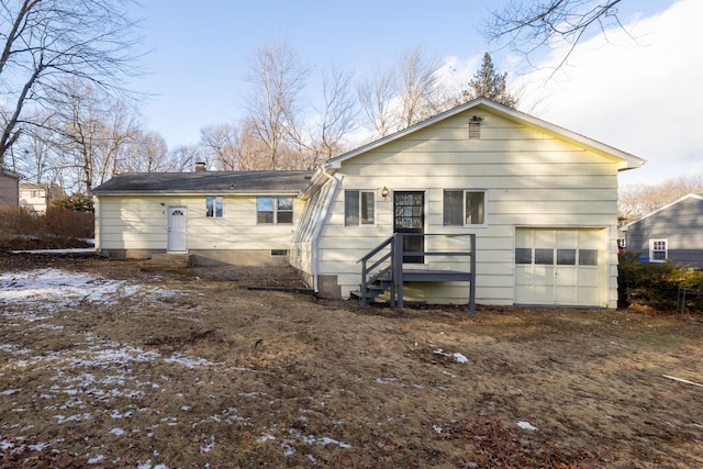 rear view of house featuring a garage