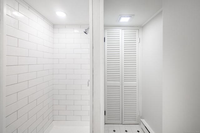 bathroom featuring tile patterned floors and a tile shower