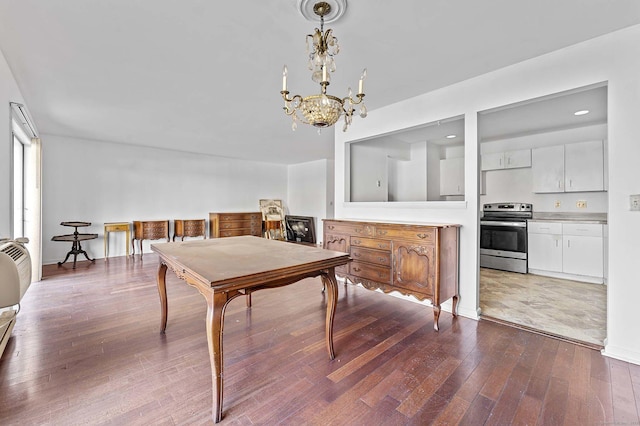 dining room featuring hardwood / wood-style flooring and a notable chandelier