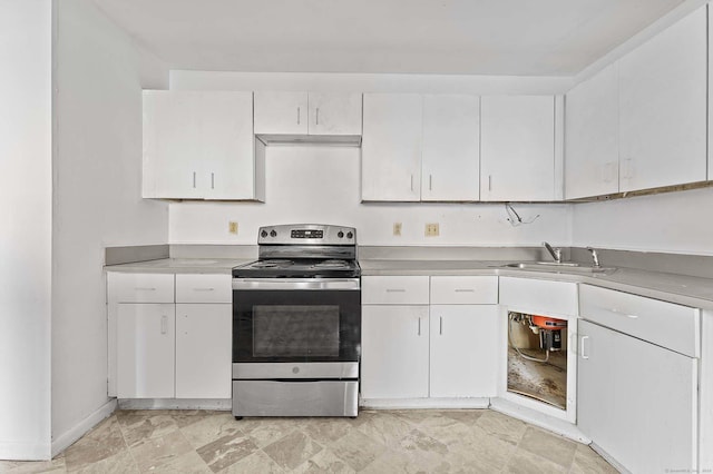 kitchen featuring stainless steel electric stove, sink, and white cabinets