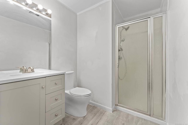 bathroom with vanity, wood-type flooring, toilet, and walk in shower