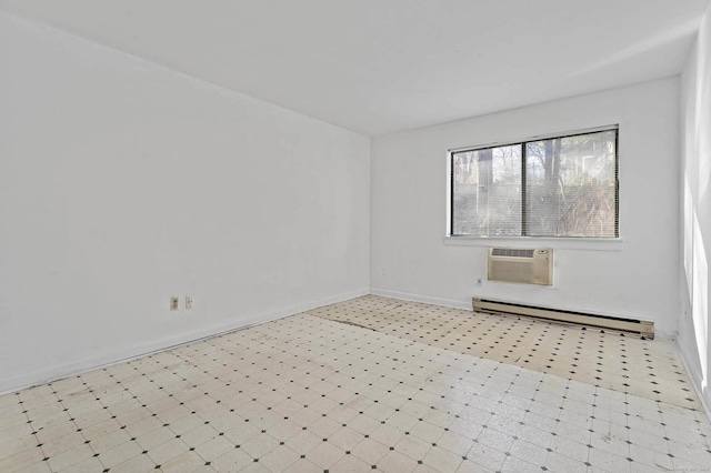 spare room with a wall mounted air conditioner and baseboard heating