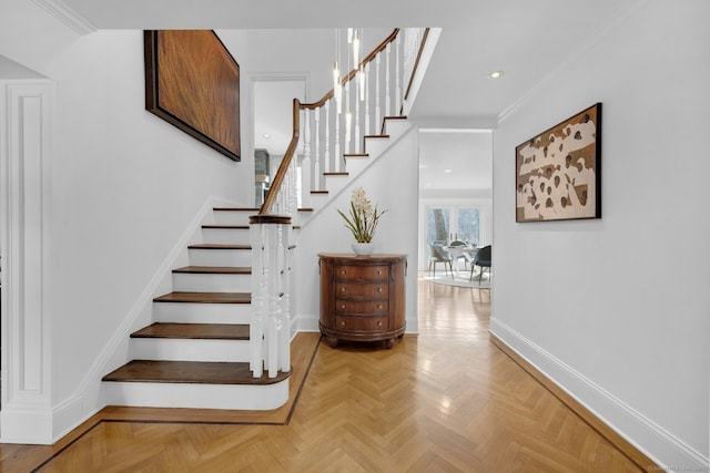 stairs featuring parquet floors and crown molding