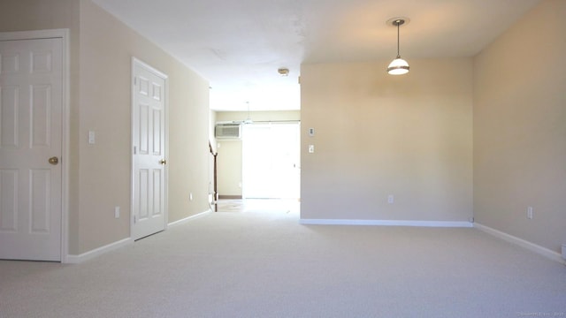 empty room with light carpet and an AC wall unit