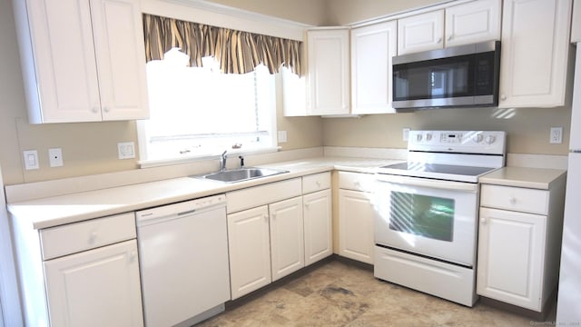 kitchen with white cabinetry, sink, and white appliances