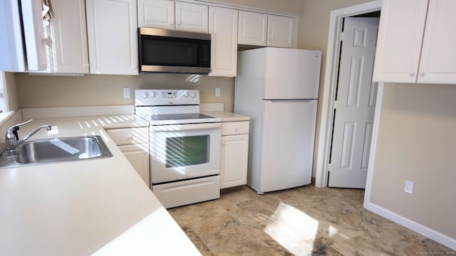 kitchen with white cabinetry, sink, and white appliances