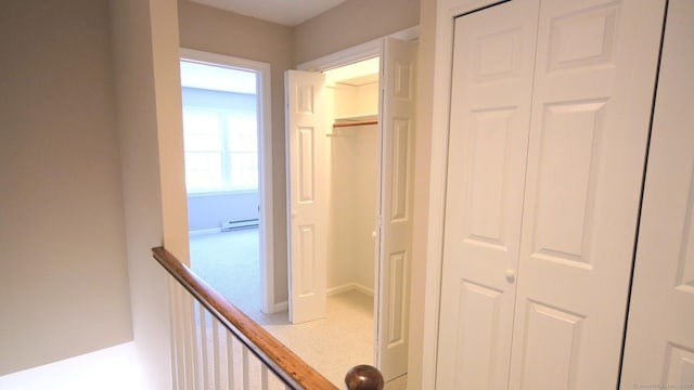 hallway featuring a baseboard heating unit