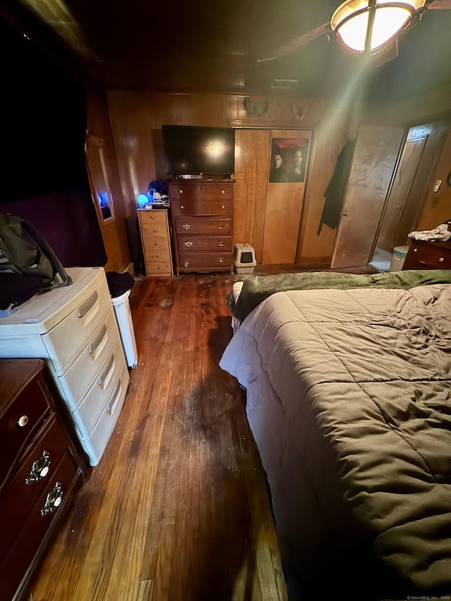 bedroom with dark wood-style flooring