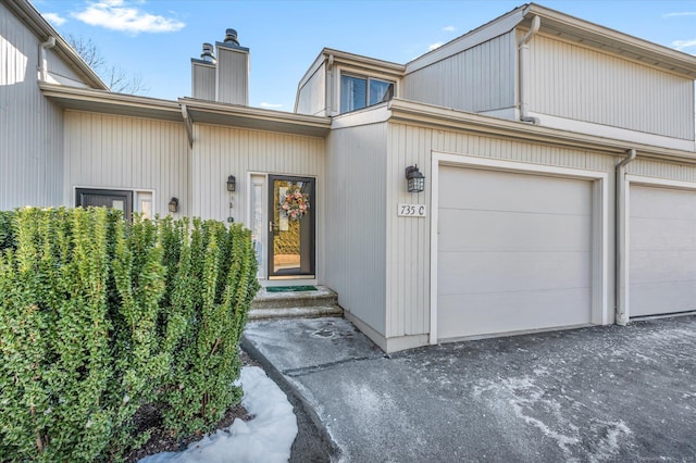 doorway to property with a garage