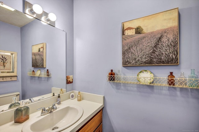 bathroom featuring vanity and toilet