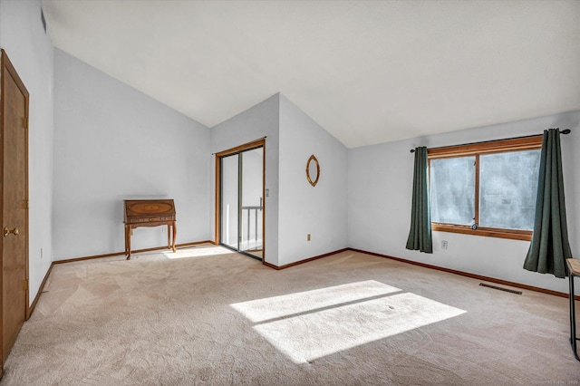 unfurnished bedroom featuring lofted ceiling, light carpet, and a closet