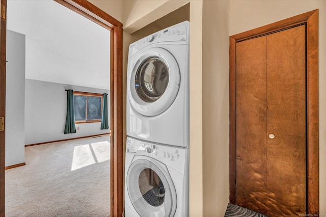 laundry area featuring stacked washer and dryer and carpet floors