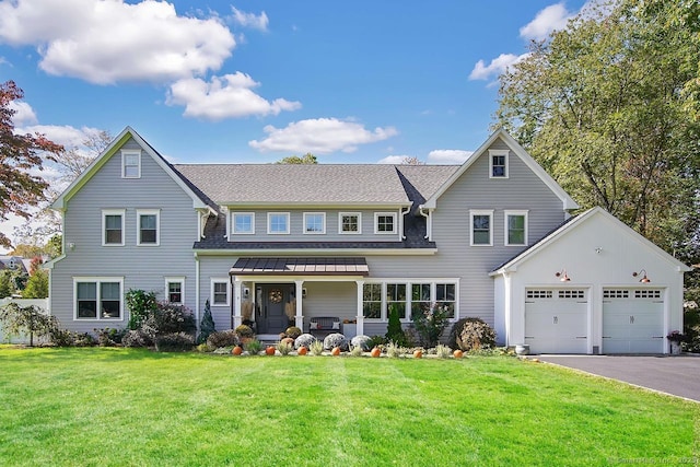 view of front facade featuring a garage, a front yard, and a porch