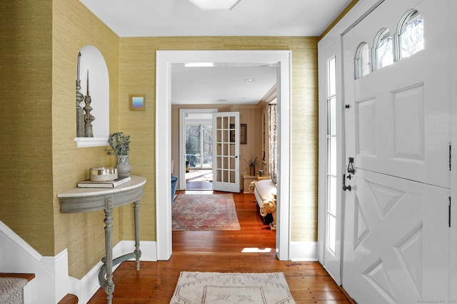 foyer entrance featuring hardwood / wood-style flooring, a wealth of natural light, and french doors