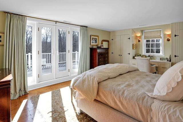 bedroom with access to outside and light wood-type flooring