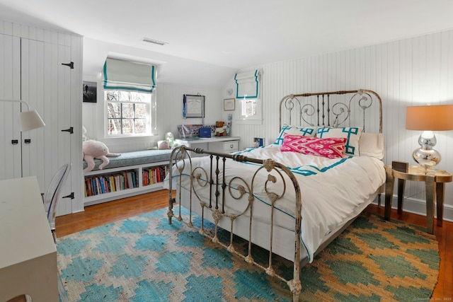 bedroom featuring wood-type flooring and vaulted ceiling