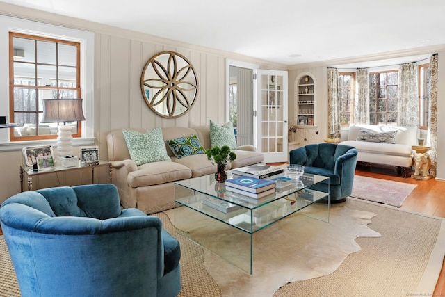 living room with ornamental molding, hardwood / wood-style floors, and a wealth of natural light