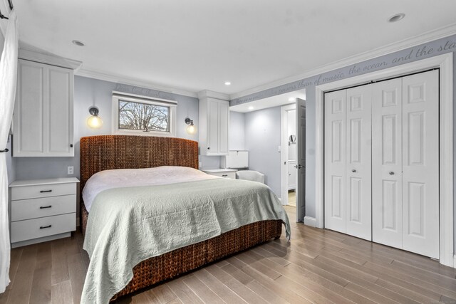 bedroom featuring ornamental molding, a closet, and light wood-type flooring