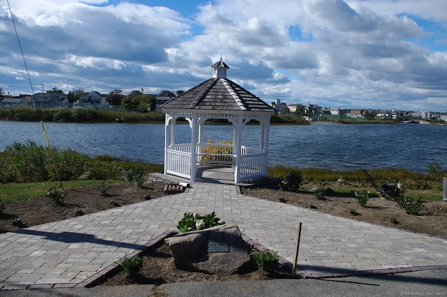 view of dock featuring a gazebo and a water view