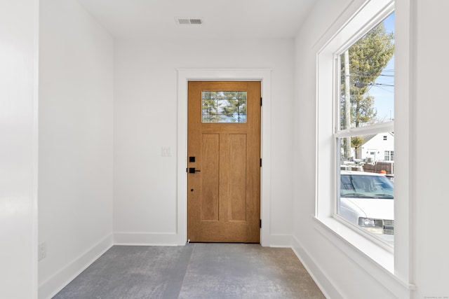 doorway to outside with concrete floors