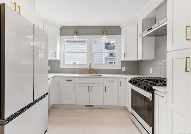 kitchen featuring white refrigerator, white cabinetry, and black range with gas cooktop