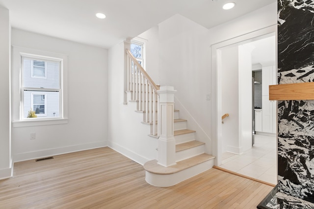 stairs with hardwood / wood-style floors