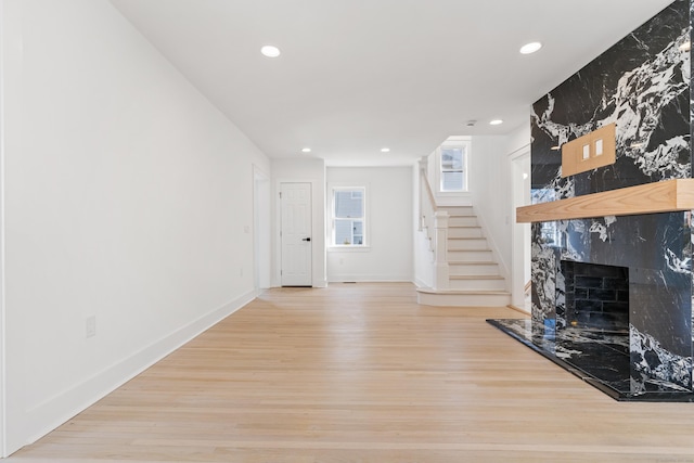 unfurnished living room featuring a fireplace and wood-type flooring