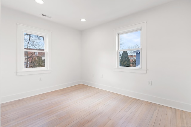 spare room with light hardwood / wood-style flooring