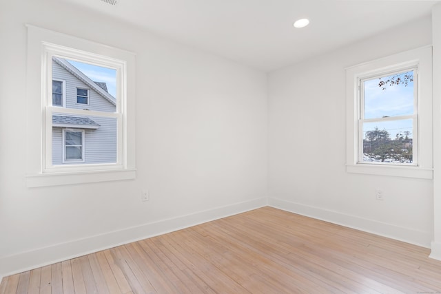 empty room with light hardwood / wood-style flooring