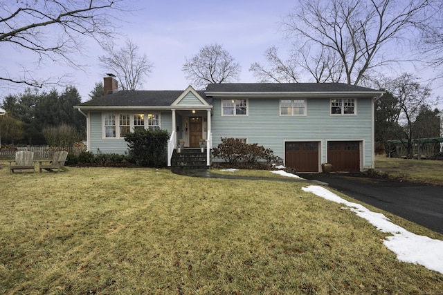 view of front of property with a garage and a front yard