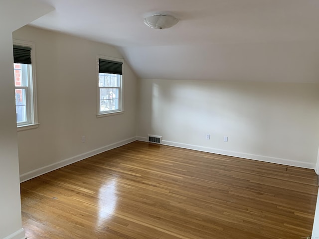 bonus room featuring light hardwood / wood-style floors and vaulted ceiling