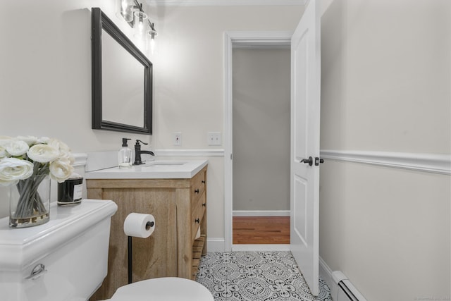 bathroom with tile patterned flooring, vanity, and toilet