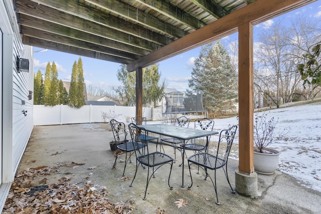 snow covered patio featuring a trampoline