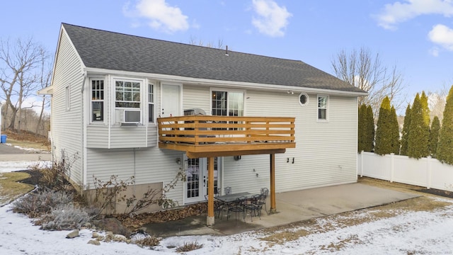 snow covered rear of property featuring cooling unit and a deck