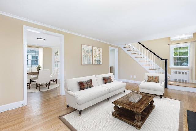 57 Saint James St, West Hartford, CT 06119 - living room with radiator, light wood-style flooring, stairway, ornamental molding, and a wall unit AC