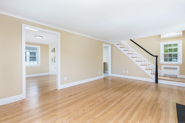 57 Saint James St, West Hartford, CT 06119 - unfurnished living room with radiator heating unit, stairs, light wood finished floors, ornamental molding, and baseboards