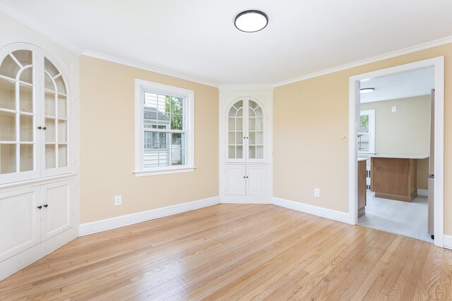 57 Saint James St, West Hartford, CT 06119 - spare room featuring light wood finished floors, crown molding, and baseboards